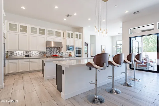 a kitchen with cabinets and chairs