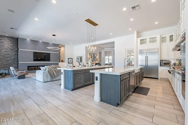 a large kitchen with stainless steel appliances lots of counter top space