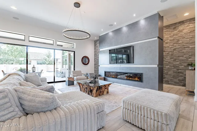 a bedroom with a bed couch and large window