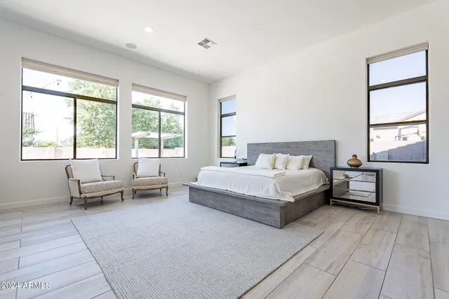 a spacious bedroom with a bed and a couch