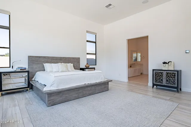 a bedroom with a bed and a couch