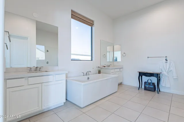 a spacious bathroom with a double vanity sink mirror and a