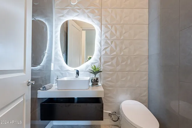 a bathroom with a sink toilet and mirror