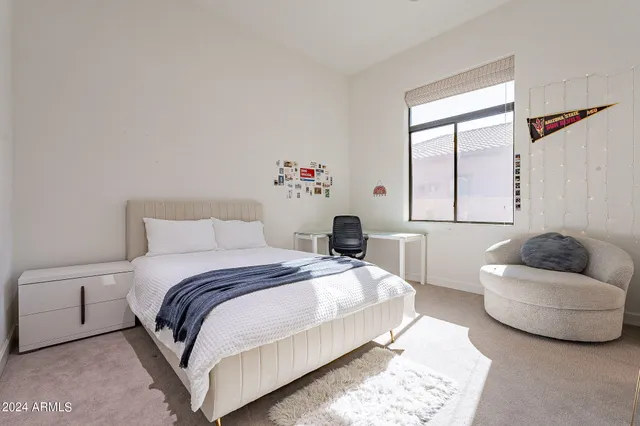 a bedroom with a bed and a couch