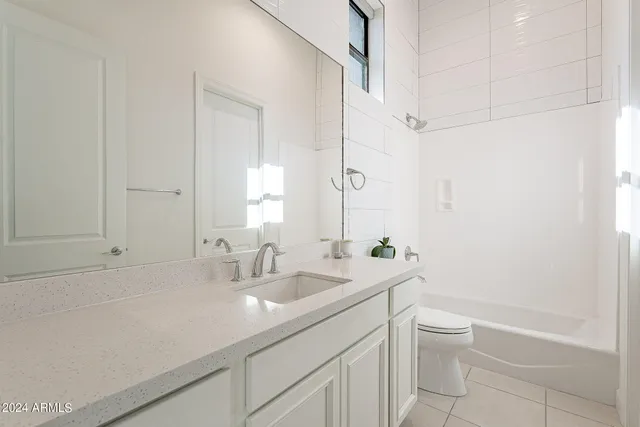 a bathroom with a sink a toilet and bathtub