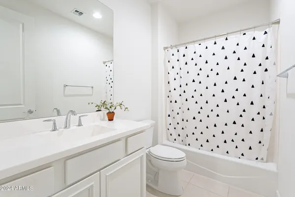 a bathroom with a sink a toilet a shower and a mirror