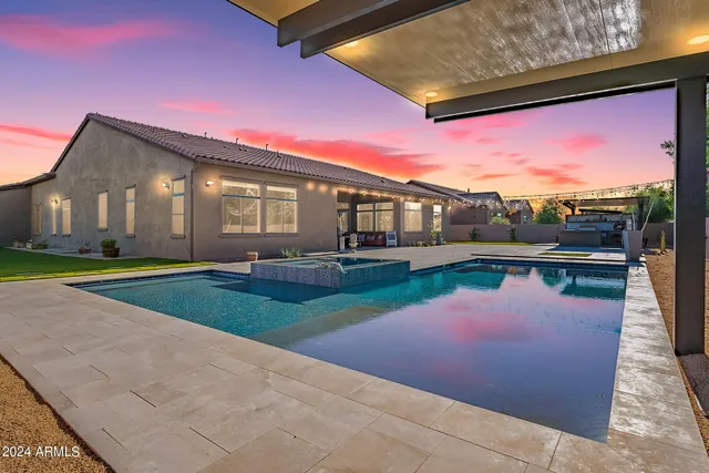 a backyard of a house with yard and outdoor seating