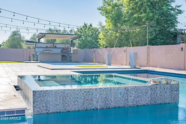 a view of swimming pool with a chairs
