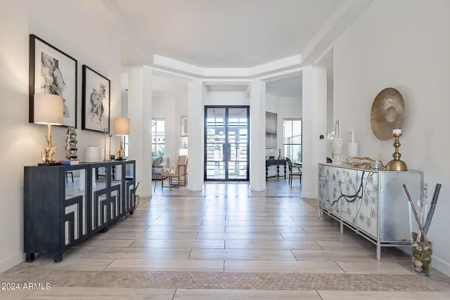 a view of a livingroom with furniture wooden floor and windows