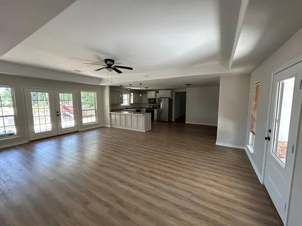 wooden floor in an empty room with a window