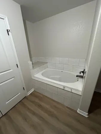 a white bath tub sitting in a bathroom