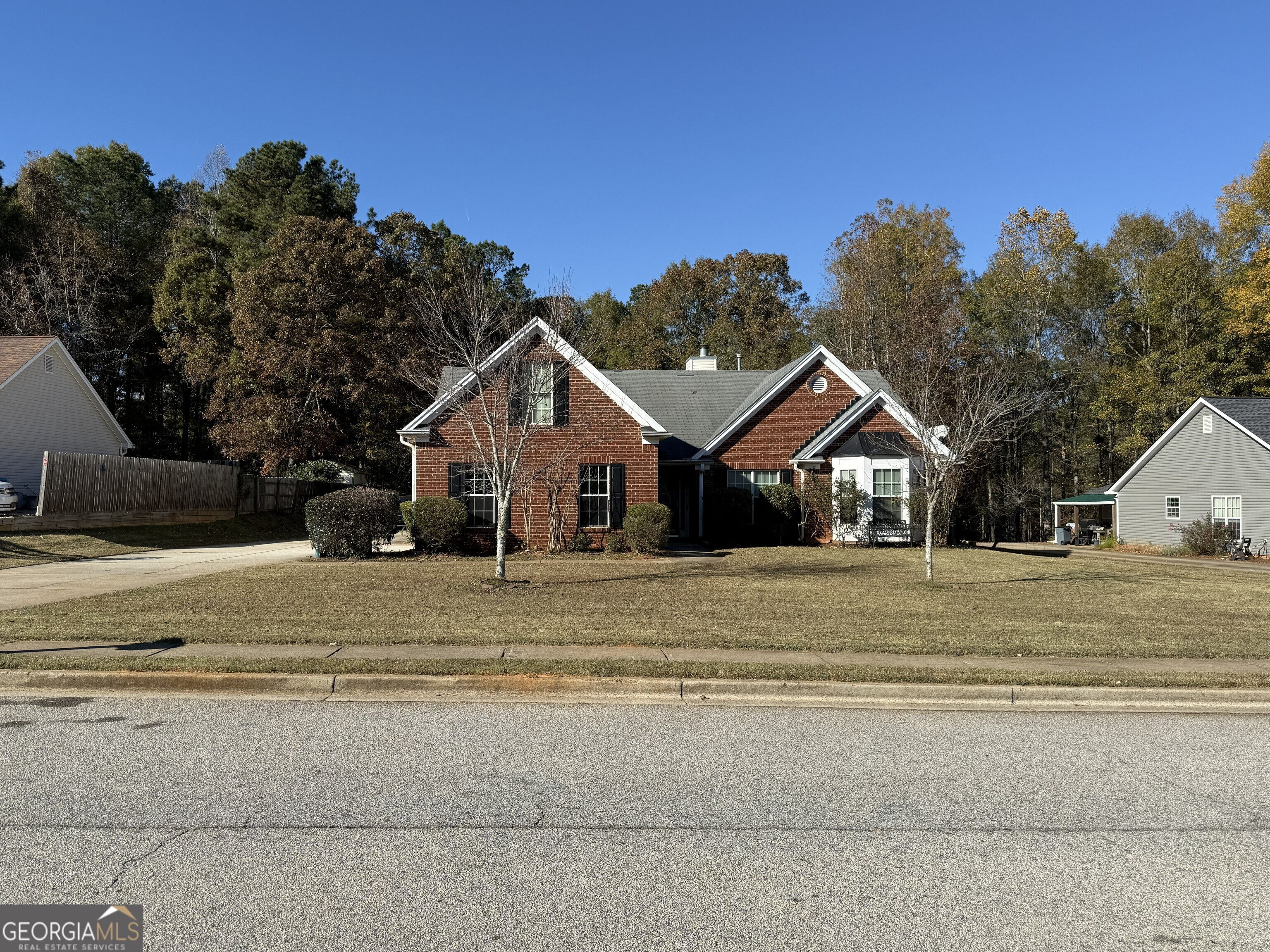 252 Sandstone Drive Hampton, GA 30228 - Photo 1 of 17 a front view of a house with a yard and garage