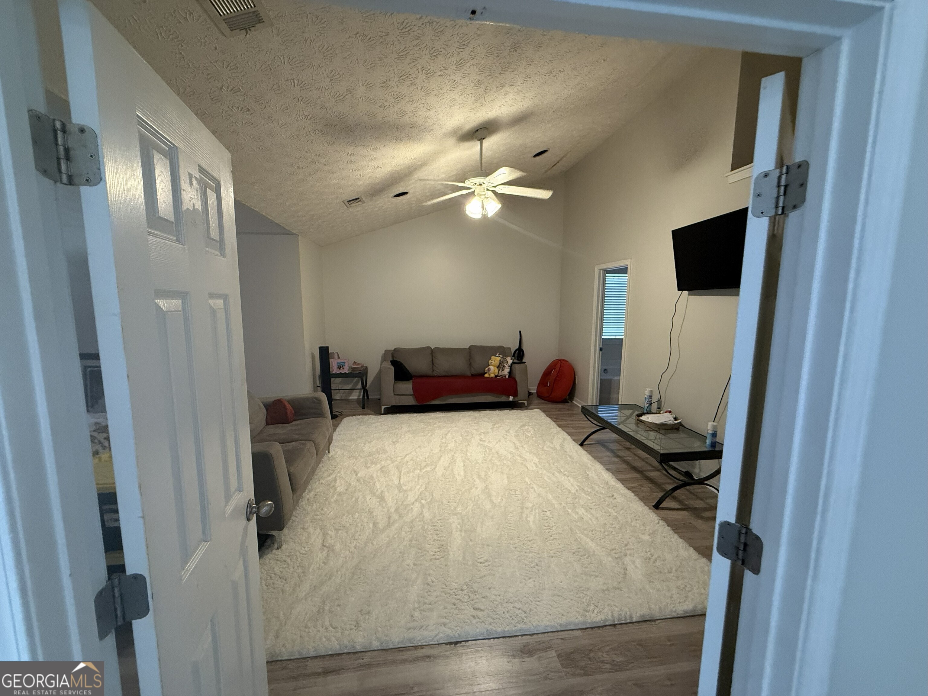 252 Sandstone Drive Hampton, GA 30228 - Photo 11 of 17 a bed room with a bed and a chandelier