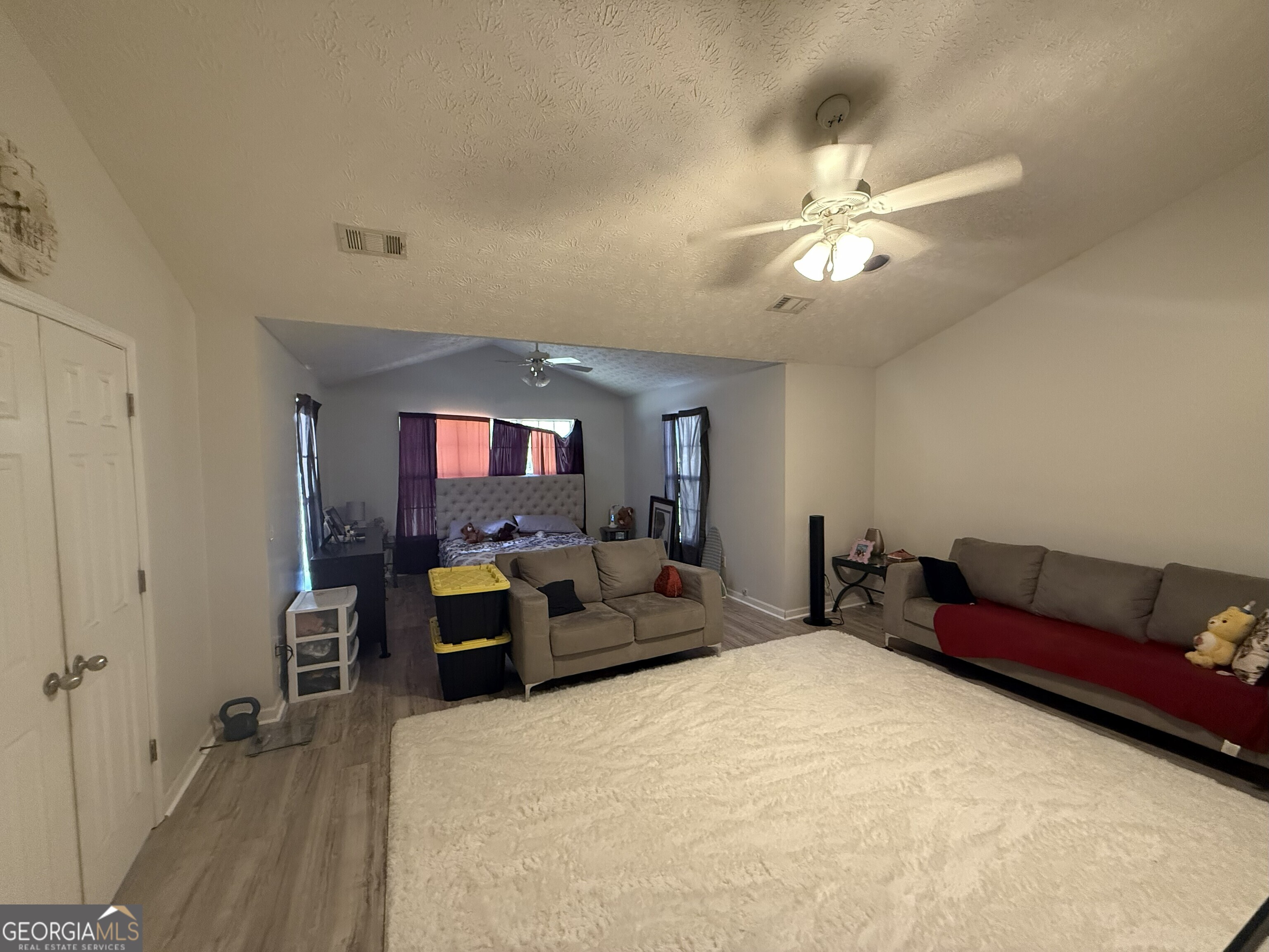 252 Sandstone Drive Hampton, GA 30228 - Photo 12 of 17 a living room with furniture and a chandelier