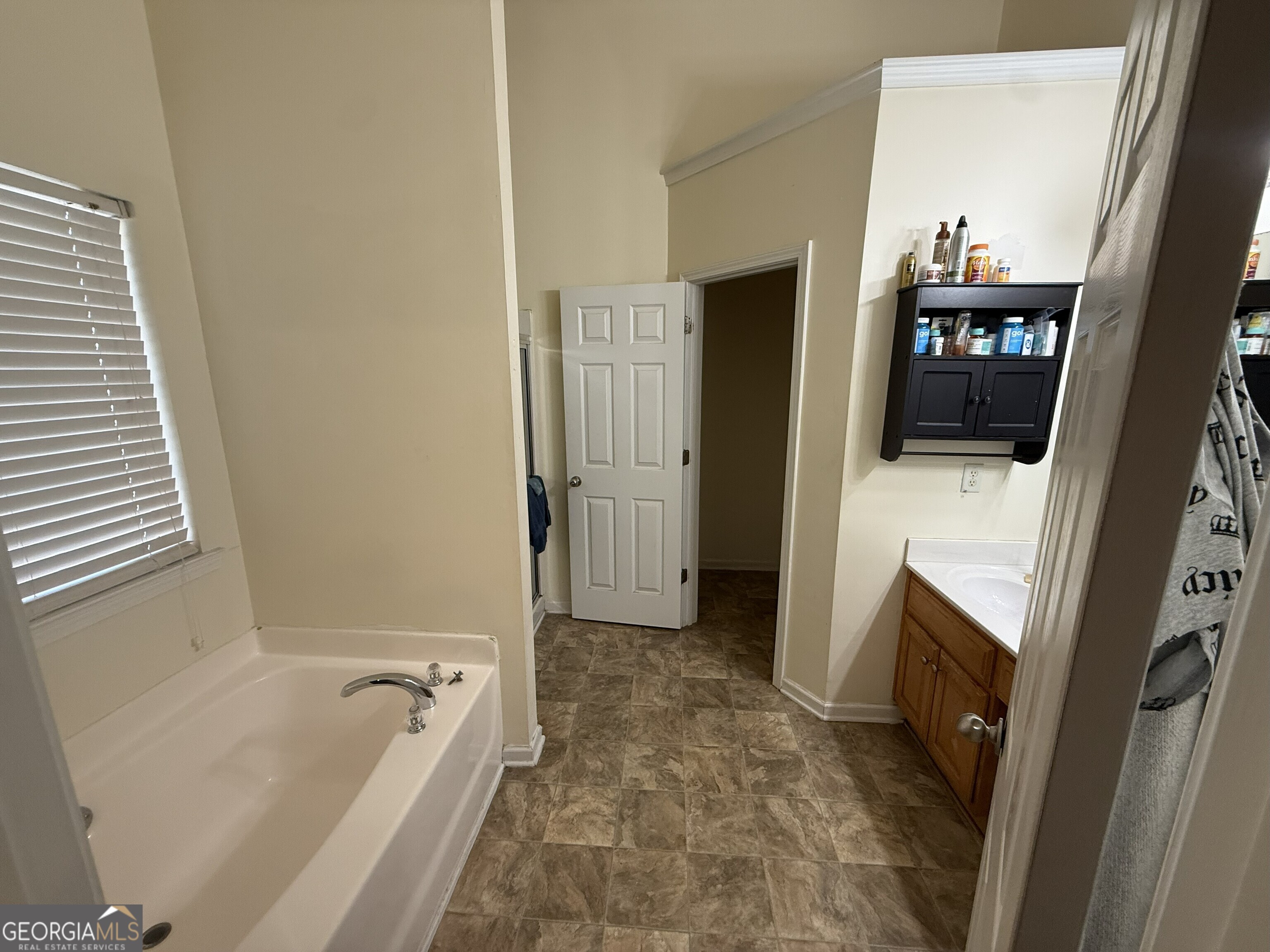 252 Sandstone Drive Hampton, GA 30228 - Photo 14 of 17 a bathroom with a tub a sink and a large mirror