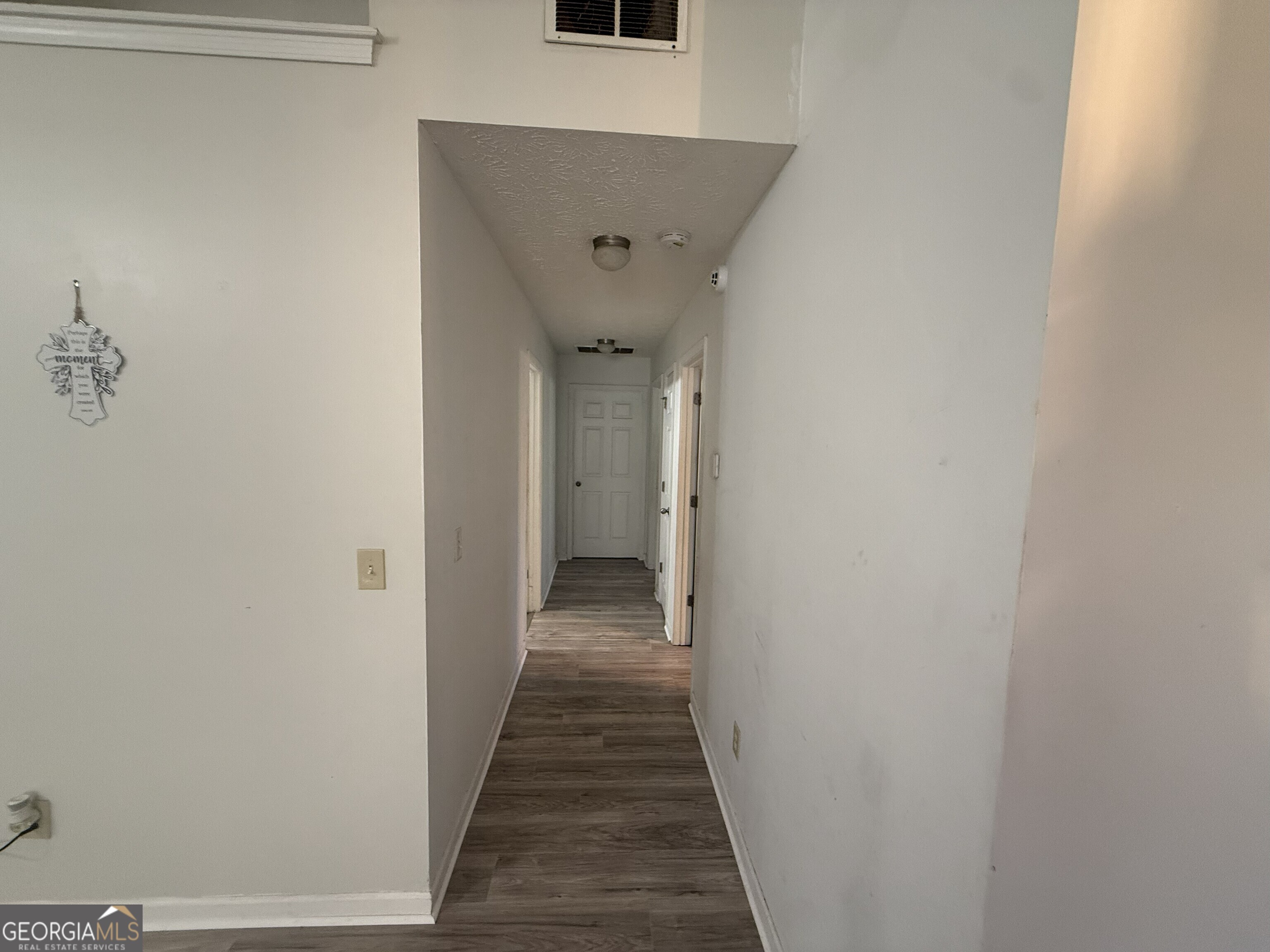 252 Sandstone Drive Hampton, GA 30228 - Photo 15 of 17 a view of a hallway with wooden floor and closet