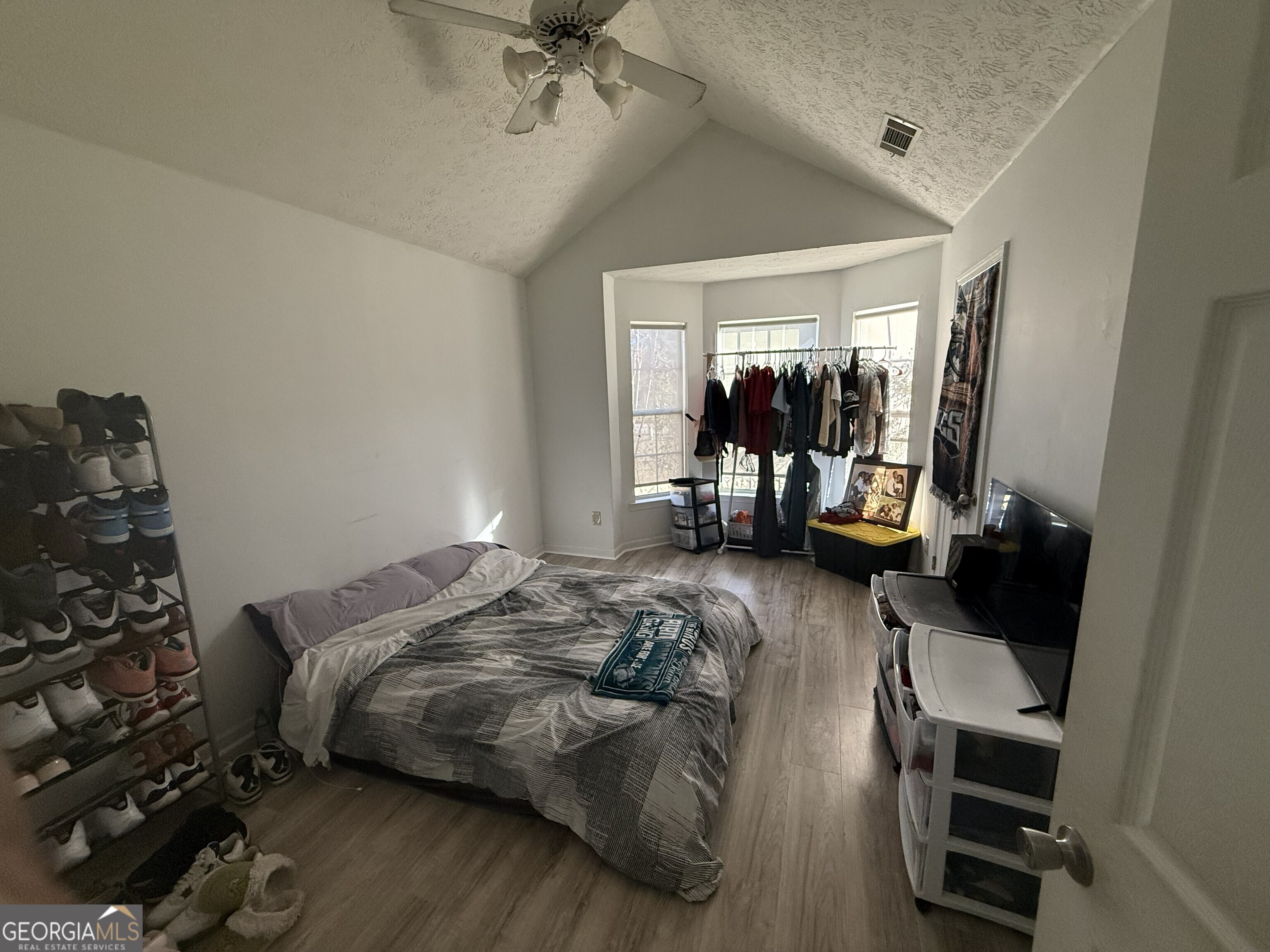 252 Sandstone Drive Hampton, GA 30228 - Photo 16 of 17 a bedroom with a bed and a mirror