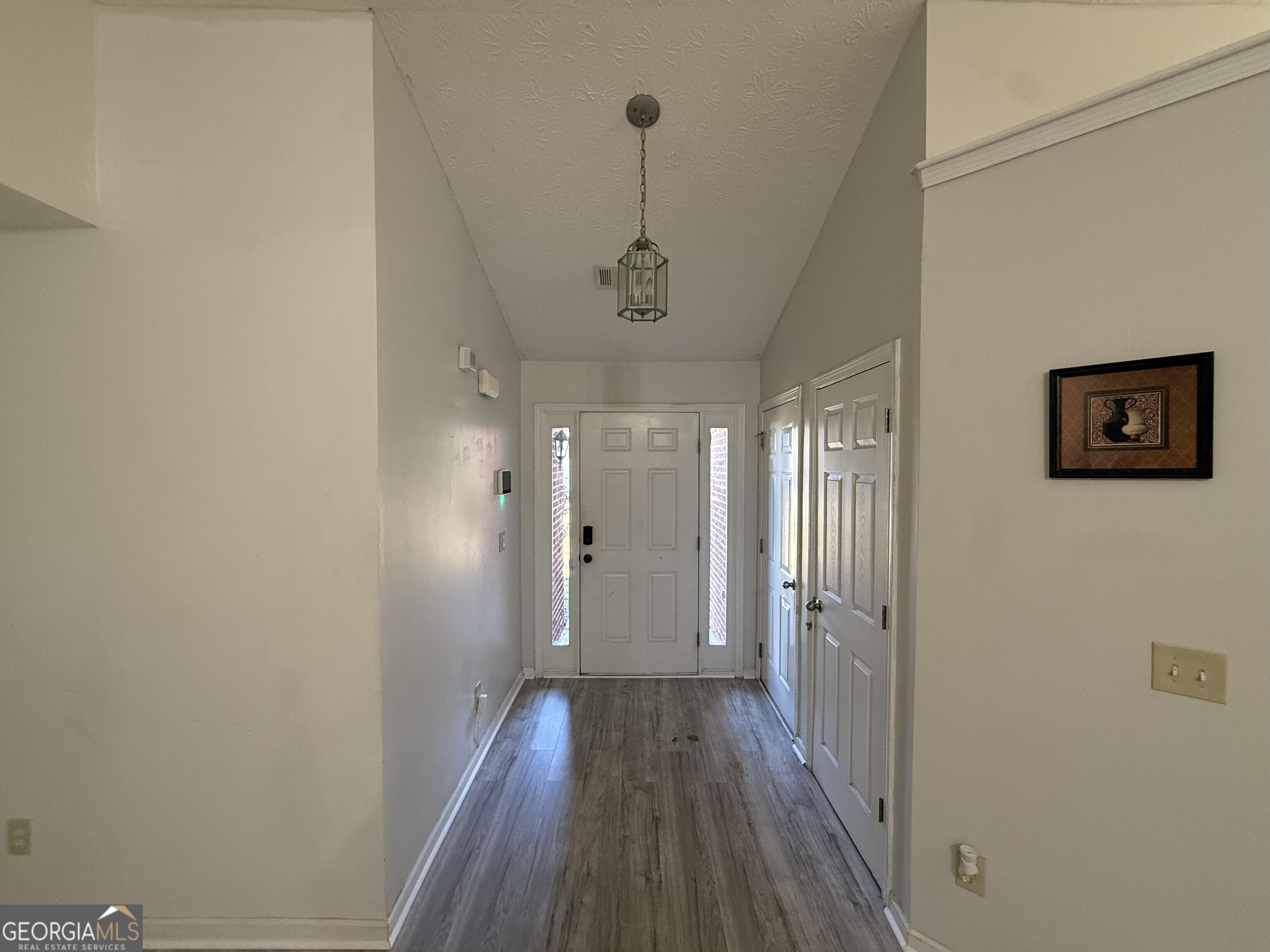 252 Sandstone Drive Hampton, GA 30228 - Photo 4 of 17 a view of a hallway with wooden floor