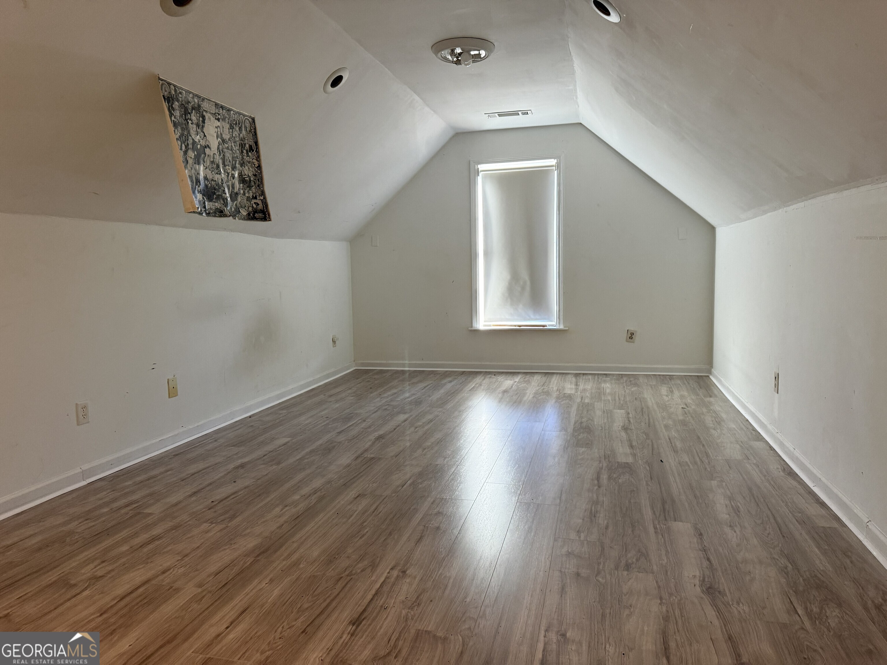 252 Sandstone Drive Hampton, GA 30228 - Photo 8 of 17 an empty room with wooden floor and windows