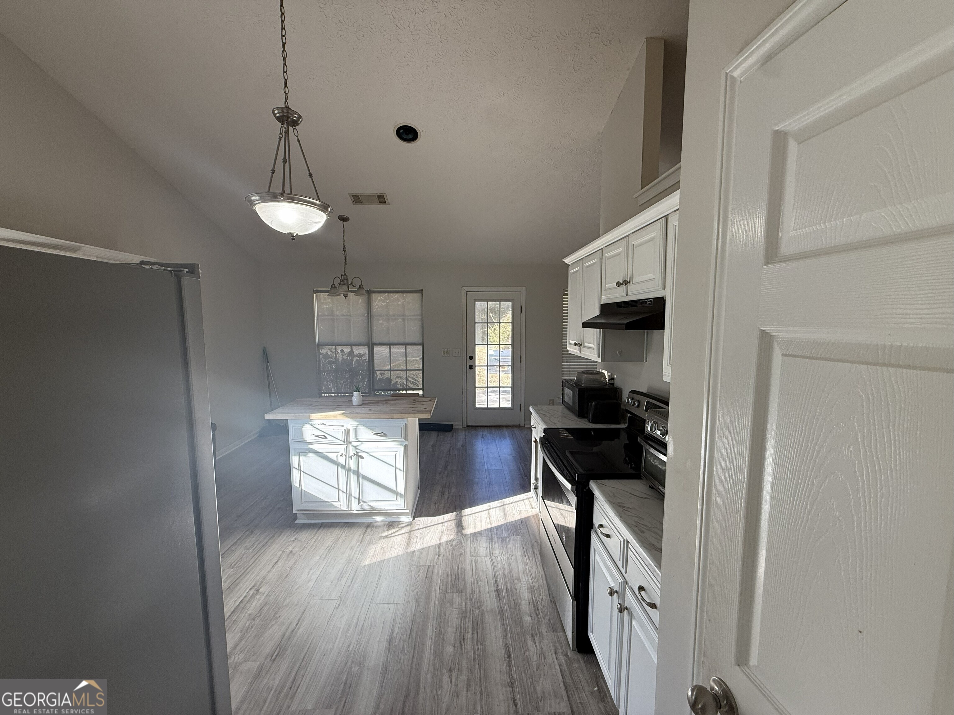 252 Sandstone Drive Hampton, GA 30228 - Photo 9 of 17 a living room with furniture and a wooden floor
