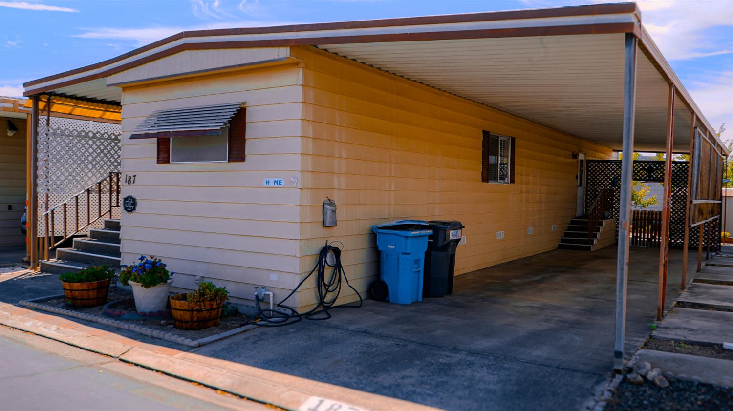 a backyard of a house with potted plants