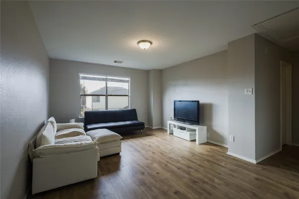 a living room with furniture window and a flat screen tv