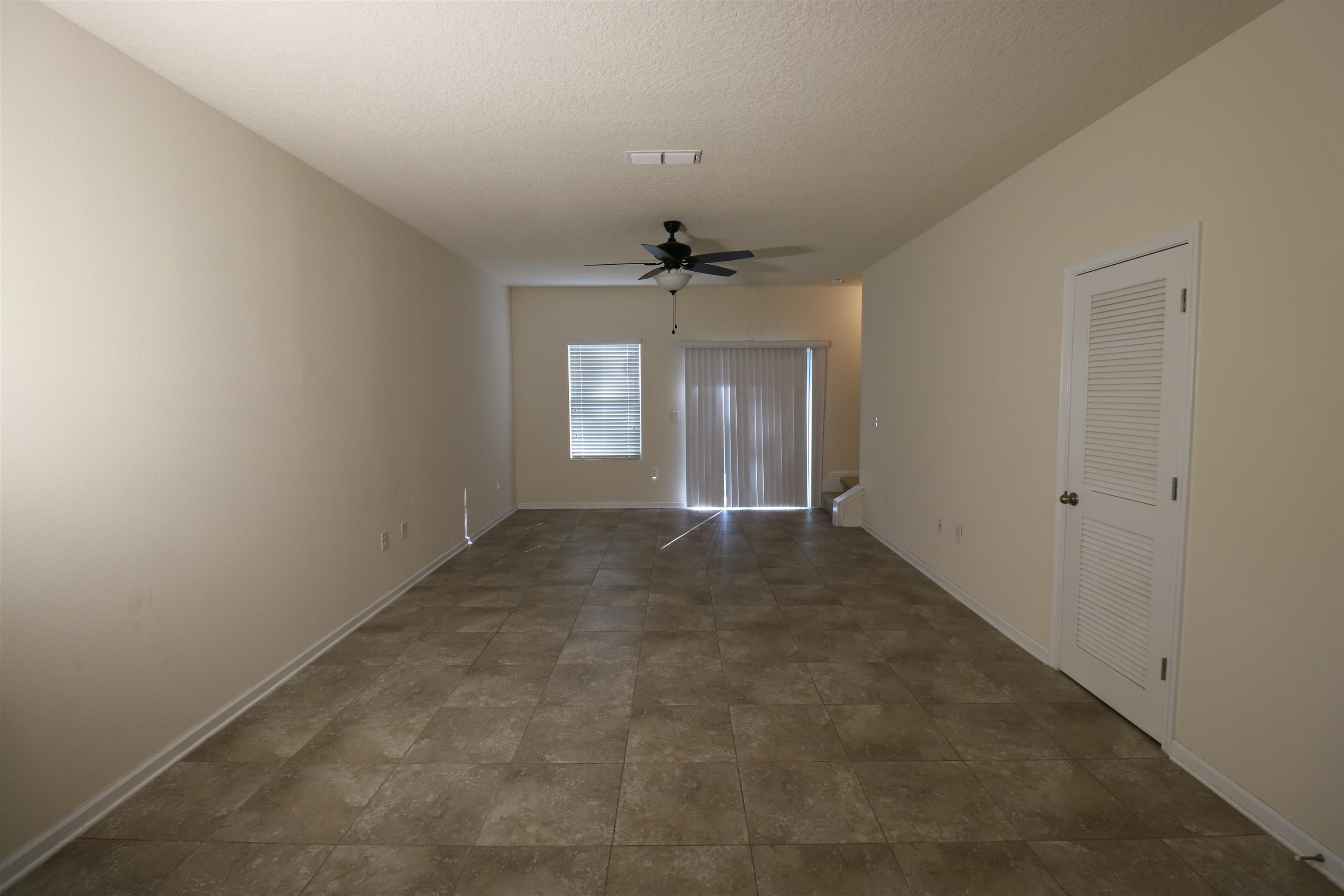 638 Servia Drive St. Johns, FL 32259 - Photo 6 of 27 an empty room with windows and a ceiling fan