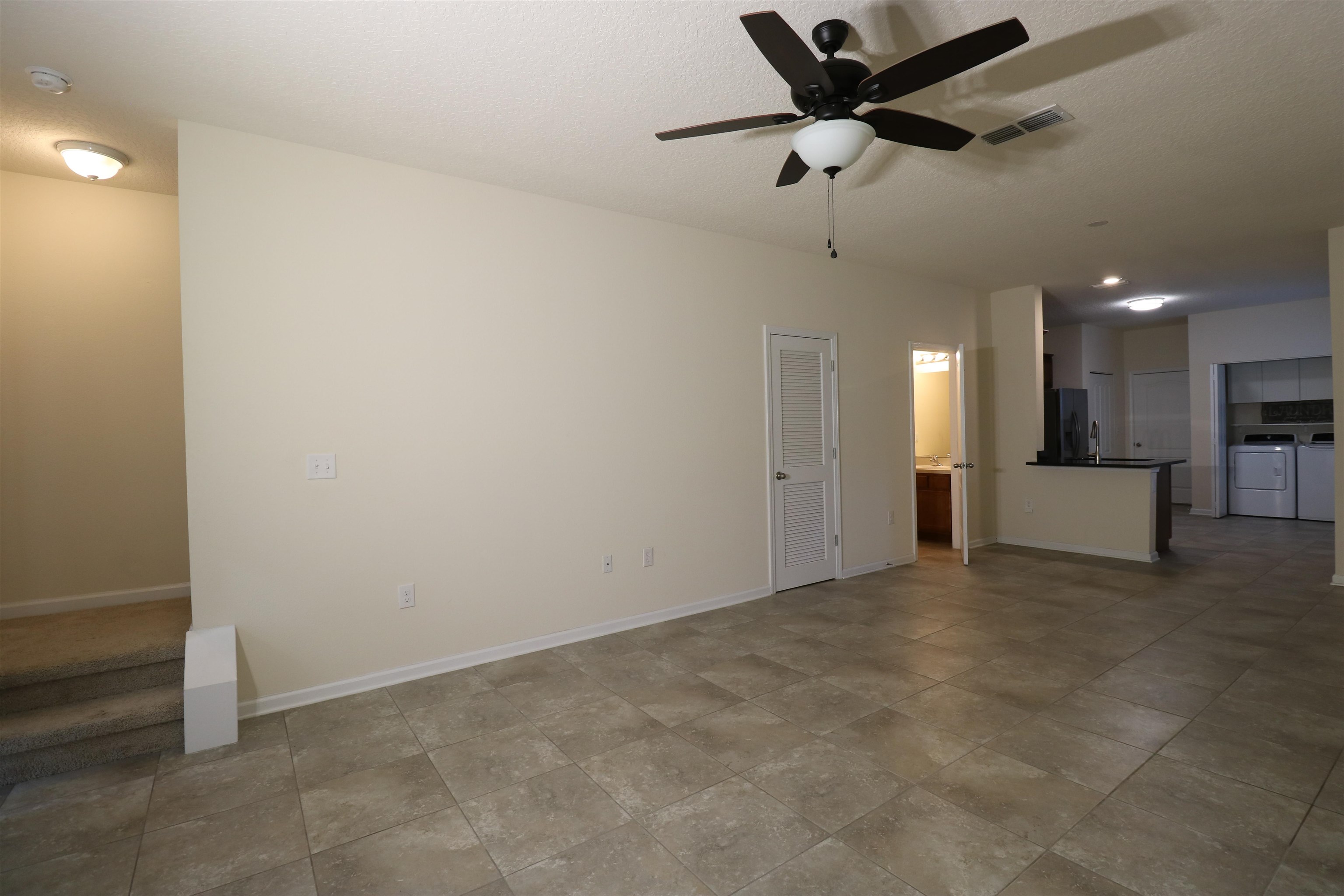 638 Servia Drive St. Johns, FL 32259 - Photo 7 of 27 a view of a livingroom with a ceiling fan a kitchen view and a ceiling fan
