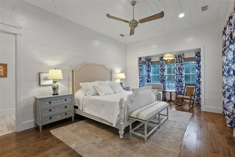 a bedroom with a bed and ceiling fan