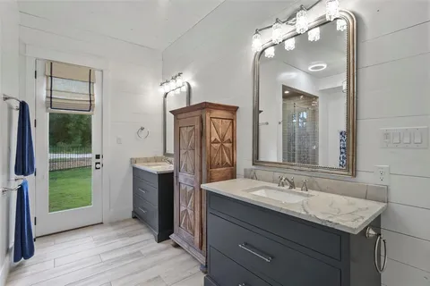 a bathroom with a double vanity sink and a mirror
