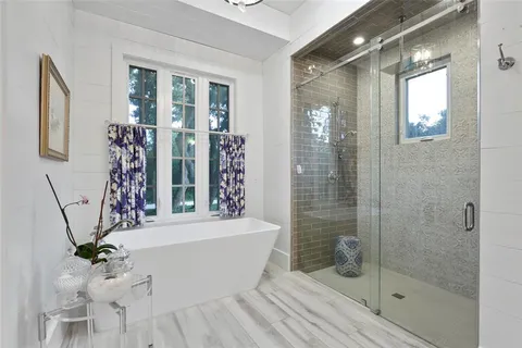 a bathroom with a bathtub a sink and a shower