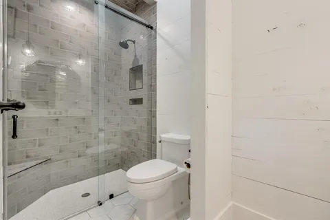 a bathroom with a toilet and shower