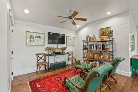a living room with furniture a rug and a flat screen tv