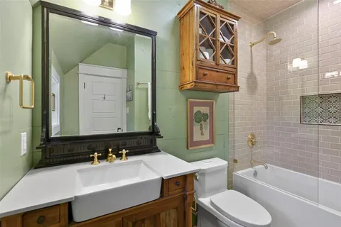 a bathroom with a sink a toilet and bathtub