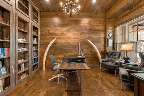 a view of a livingroom with furniture and a floor to ceiling window