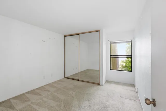 a view of a hallway with wooden floor and a yard