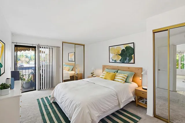 a spacious bedroom with a bed and a potted plant