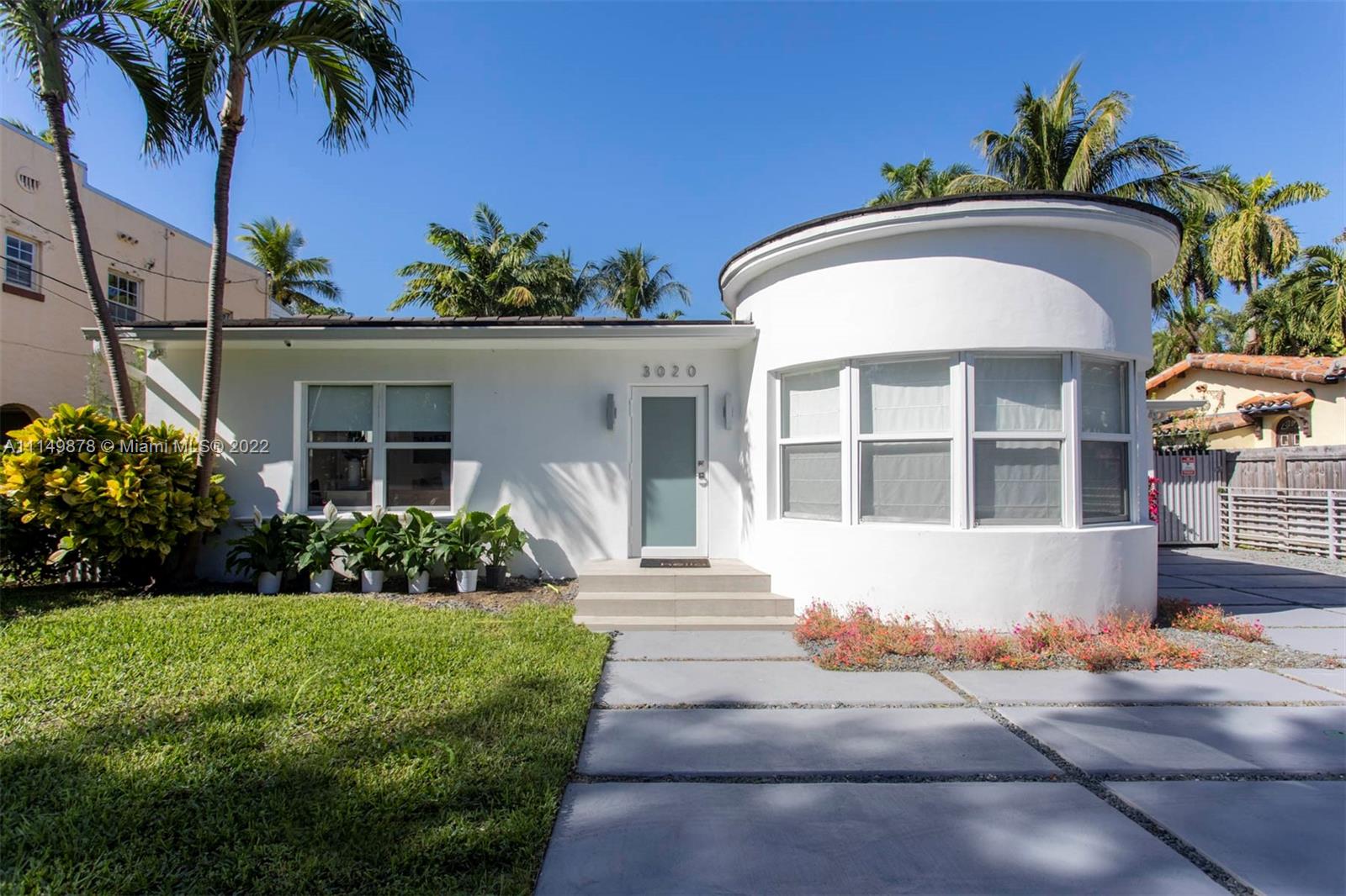 a front view of a house with a garden