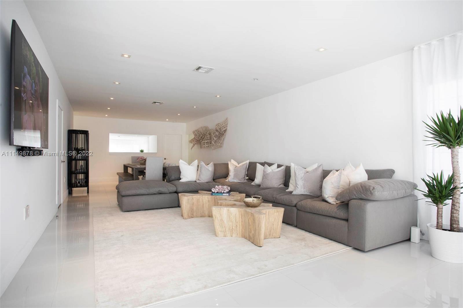 3020 Alton Road Miami Beach, FL 33140 - Photo 12 of 22 a living room with furniture and a flat screen tv