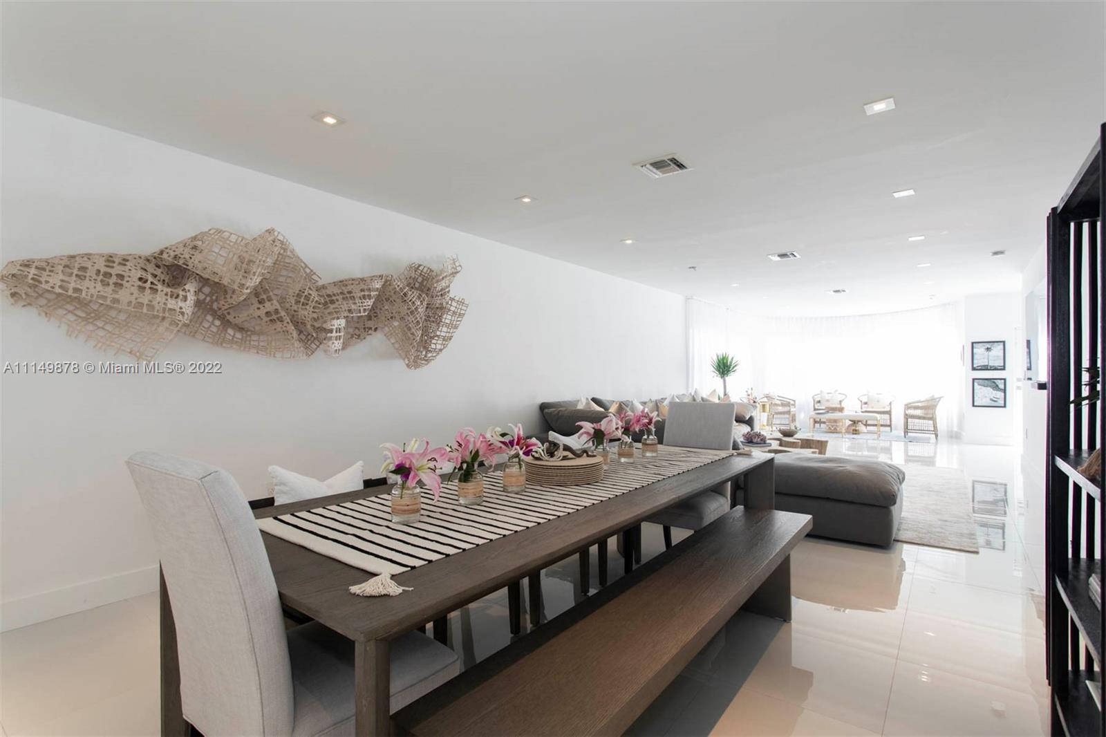 3020 Alton Road Miami Beach, FL 33140 - Photo 14 of 22 a living room with furniture and a table