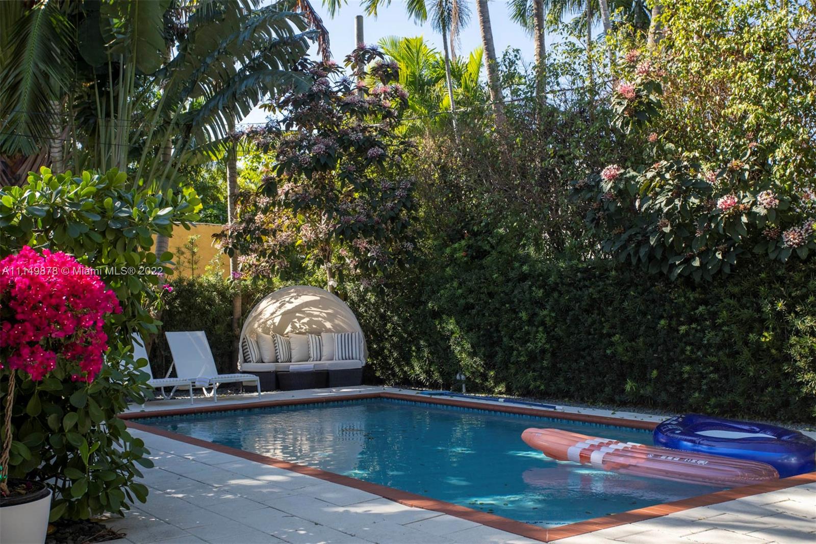 3020 Alton Road Miami Beach, FL 33140 - Photo 17 of 22 a front view of a house with swimming pool and sitting area