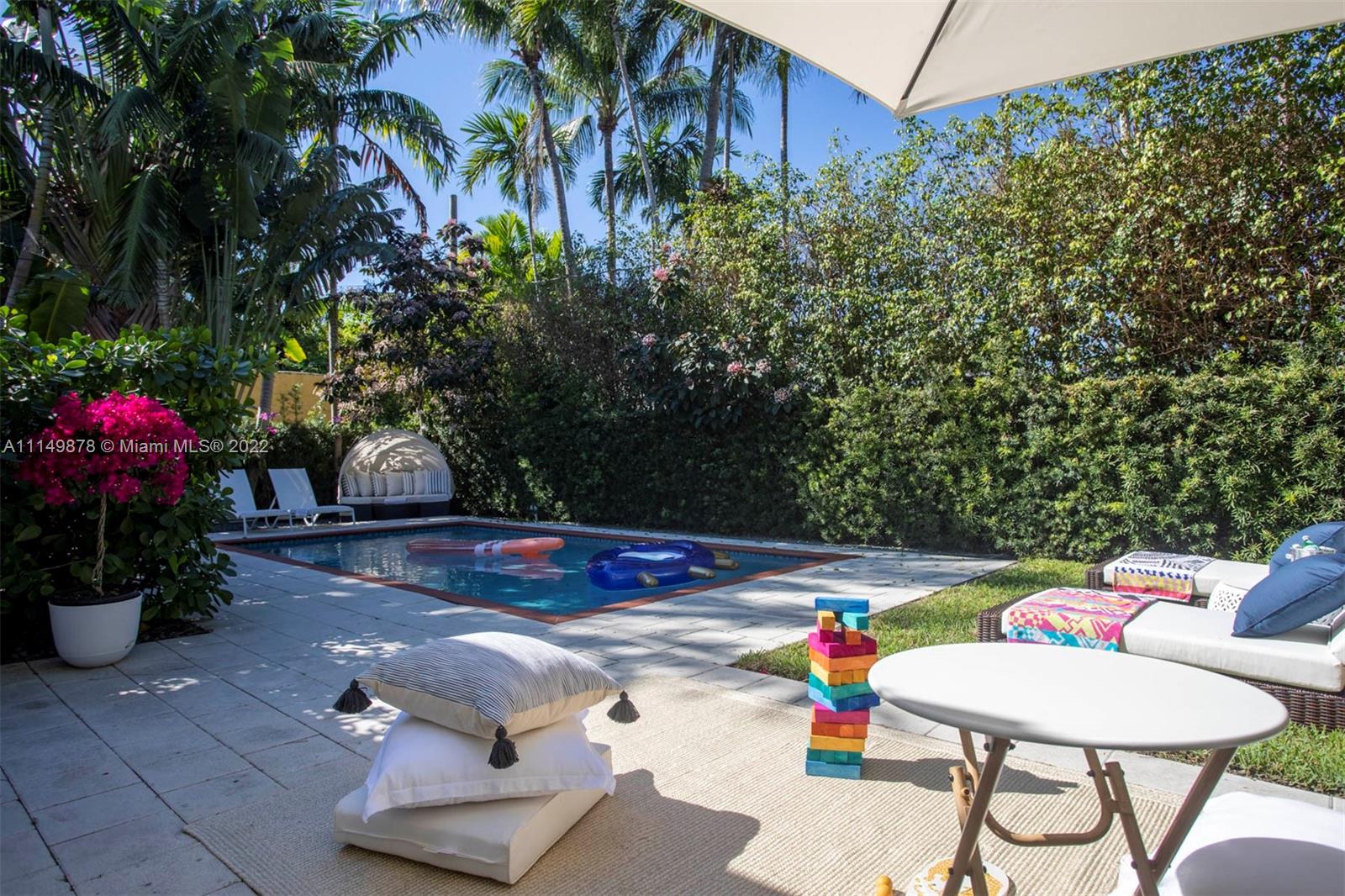 3020 Alton Road Miami Beach, FL 33140 - Photo 19 of 22 a view of a backyard with plants and chairs