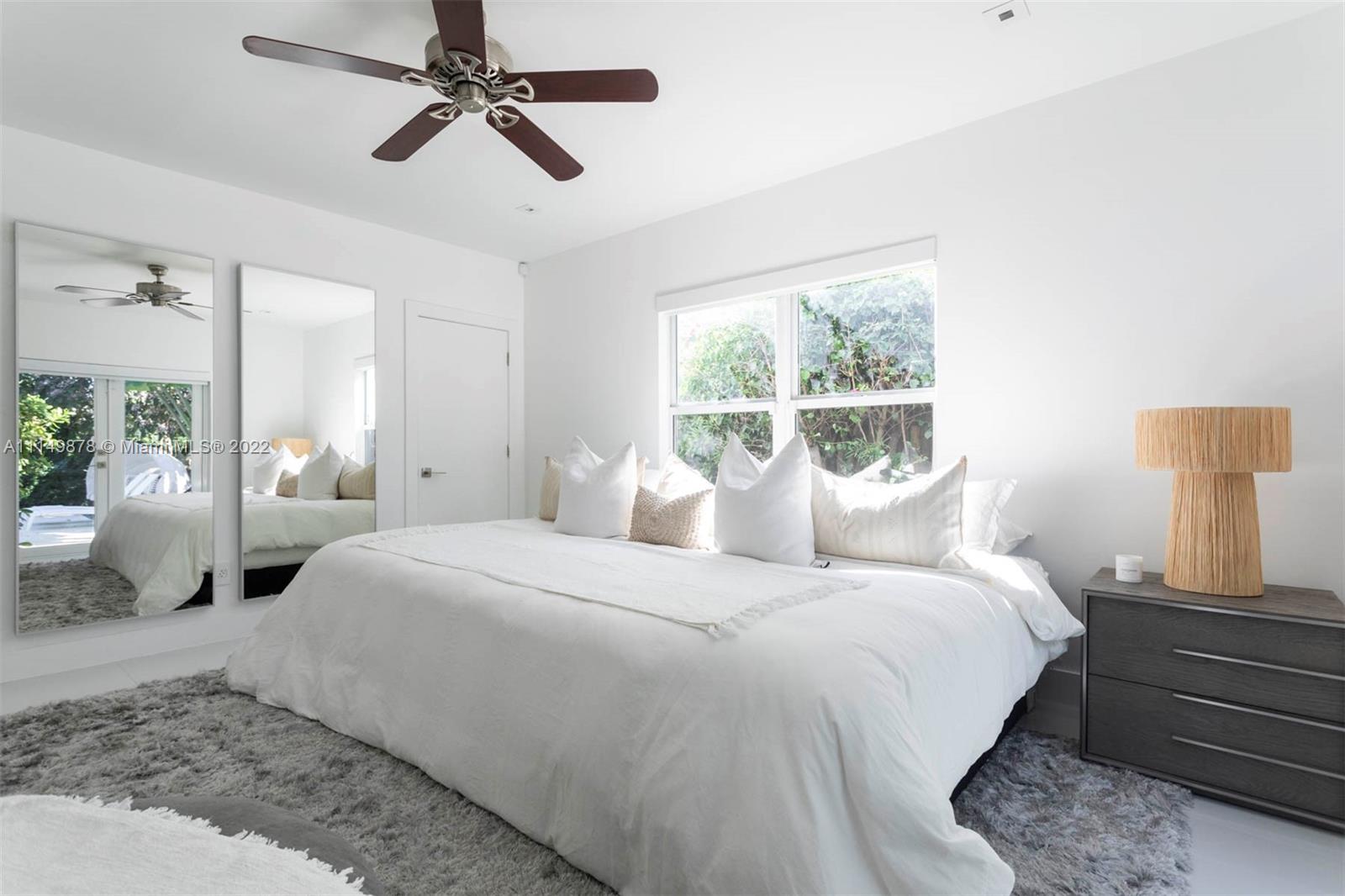 3020 Alton Road Miami Beach, FL 33140 - Photo 4 of 22 a bedroom with a large bed and a window