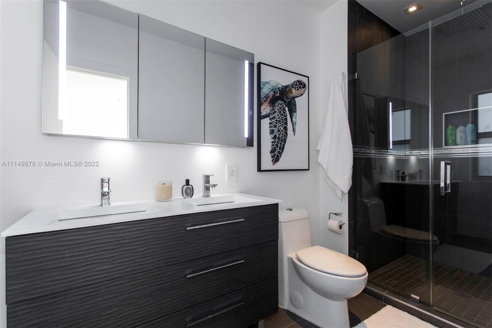 3020 Alton Road Miami Beach, FL 33140 - Photo 5 of 22 a bathroom with a toilet sink and mirror