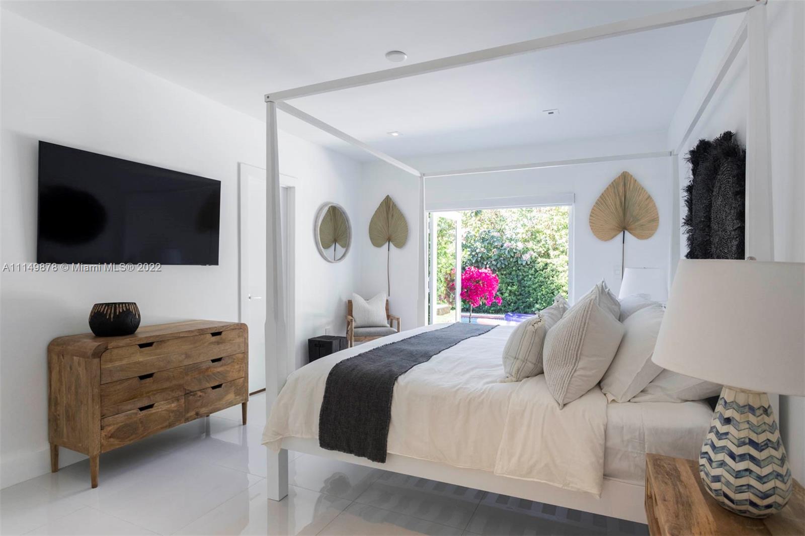 3020 Alton Road Miami Beach, FL 33140 - Photo 7 of 22 a bedroom with a bed and flat screen tv