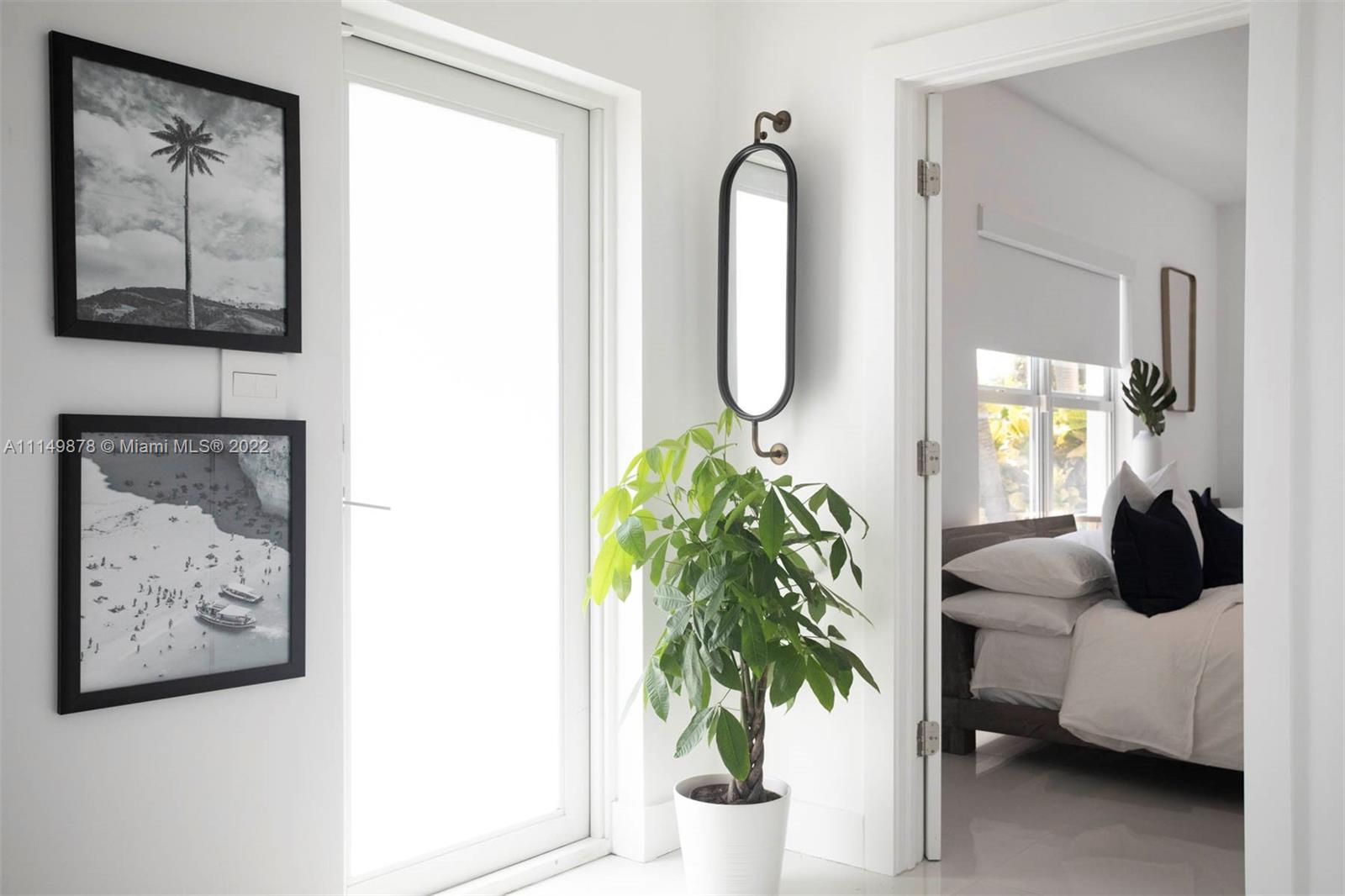 3020 Alton Road Miami Beach, FL 33140 - Photo 10 of 22 a living room with furniture and a potted plant