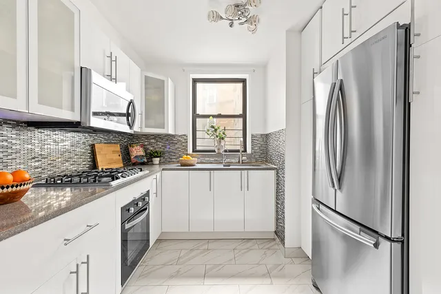 a kitchen with stainless steel appliances granite countertop a refrigerator and a sink