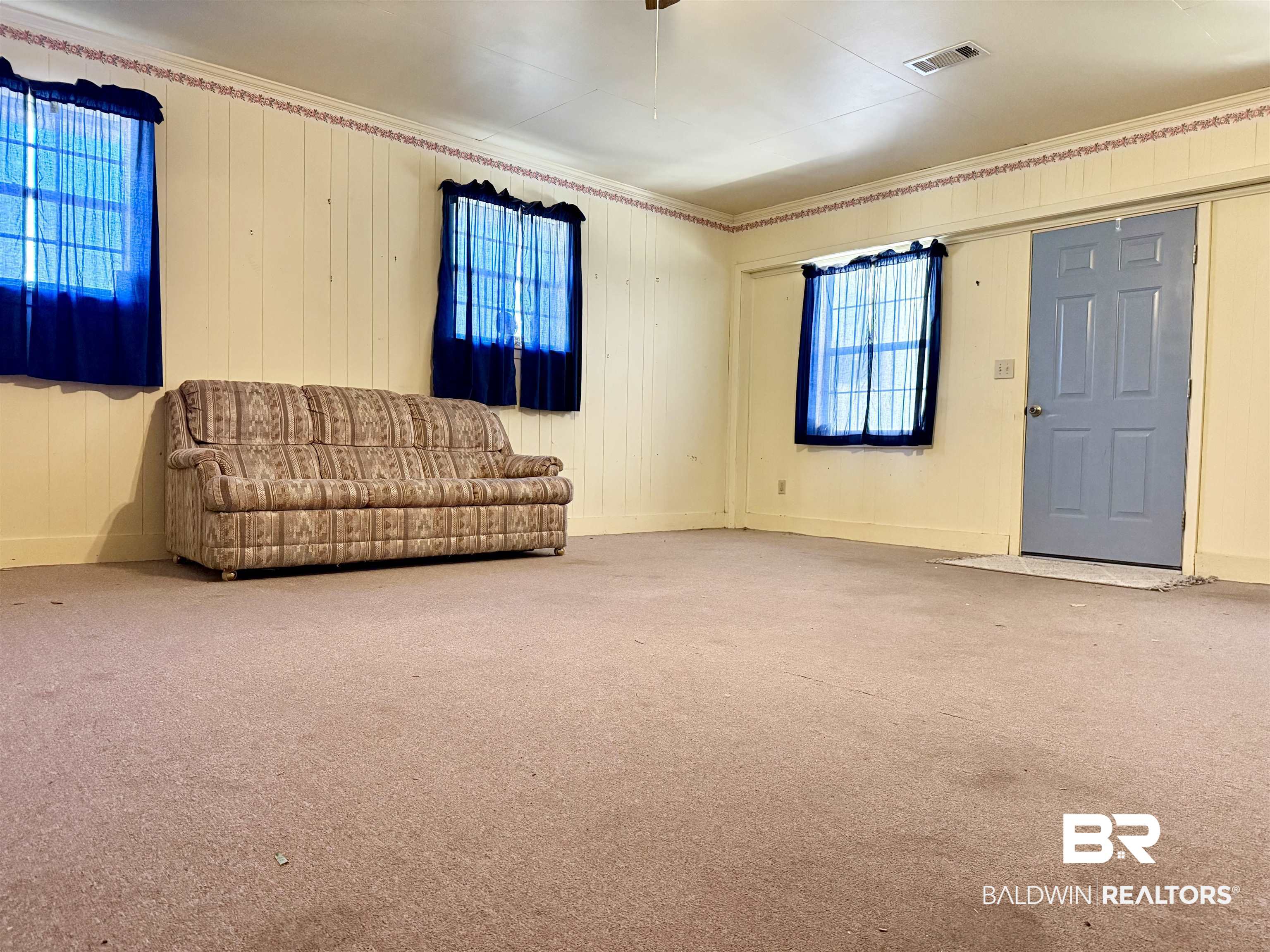 98 Evans Avenue Brewton, AL 36426 - Photo 7 of 18 Unfurnished room with carpet floors and wooden walls