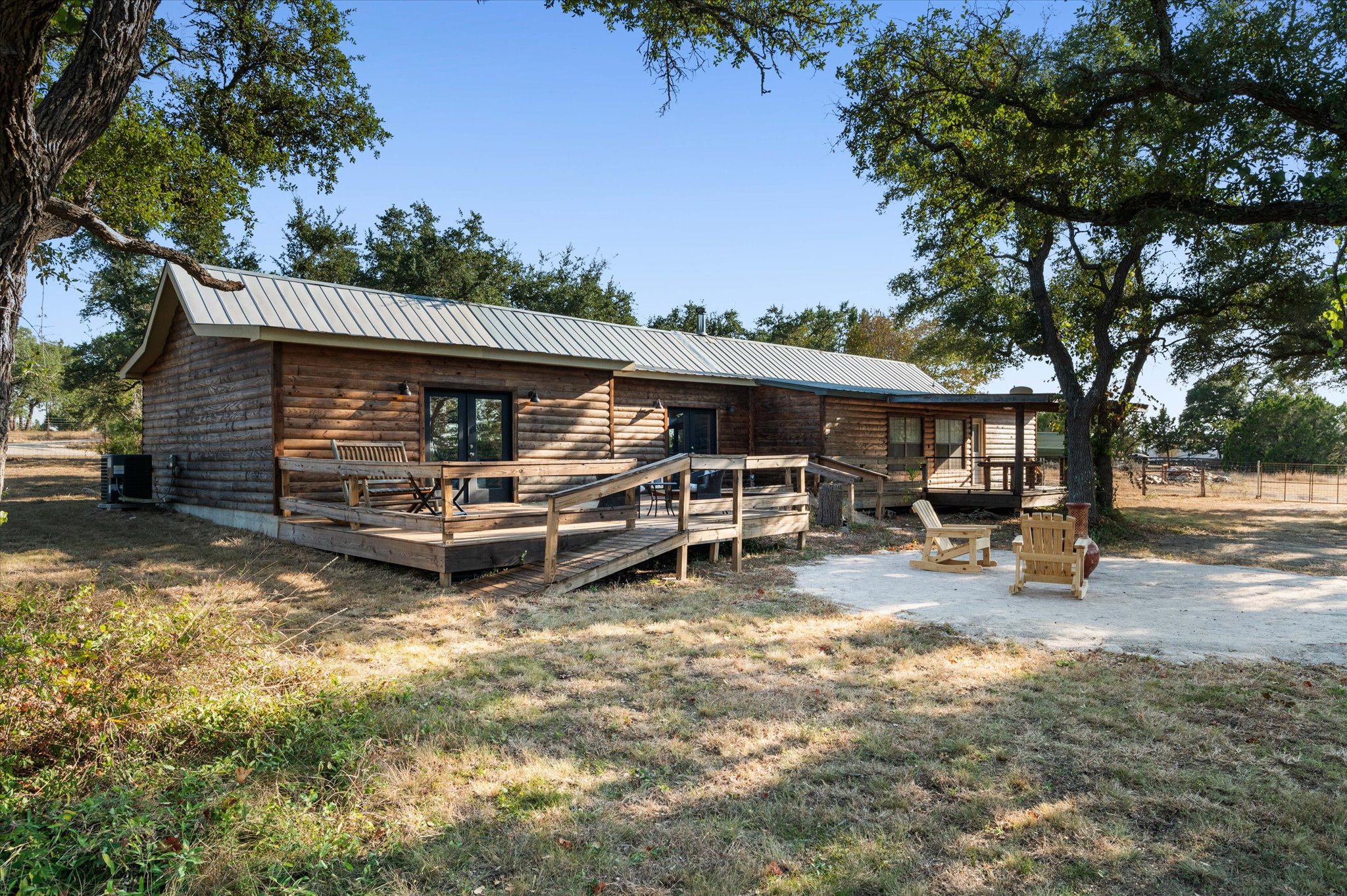 215 Go Away Road Blanco, TX 78606 - Photo 25 of 30 Backyard patio deck goes the whole length of the back of the home. Spacious back deck and outdoor seating area for relaxing, entertaining, or enjoying starry Hill Country nights. The address might be Go Away Road, but it’s the kind of place you’ll want to call home forever.