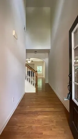 a view of entryway and hall with wooden floor